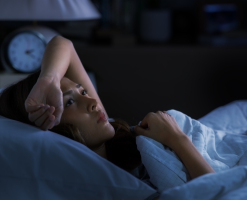 Woman awake at 2 AM struggling with perimenopause insomnia and midlife weight loss
