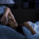 Woman awake at 2 AM struggling with perimenopause insomnia and midlife weight loss